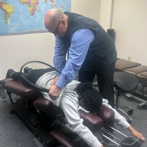 Dr. James Mattern performing a treatment on a patient's shoulder